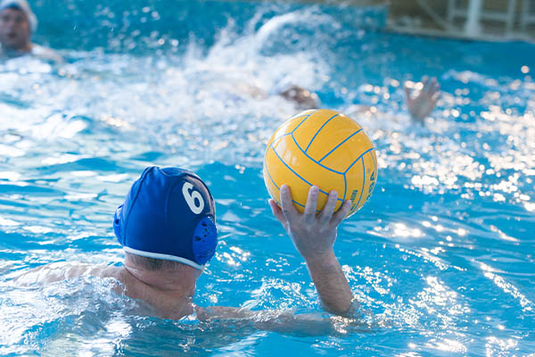 Water polo players in a pool competing
